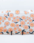 Handmade platter patterned with pink cherry blossom flowers with green and black branches. Back view.