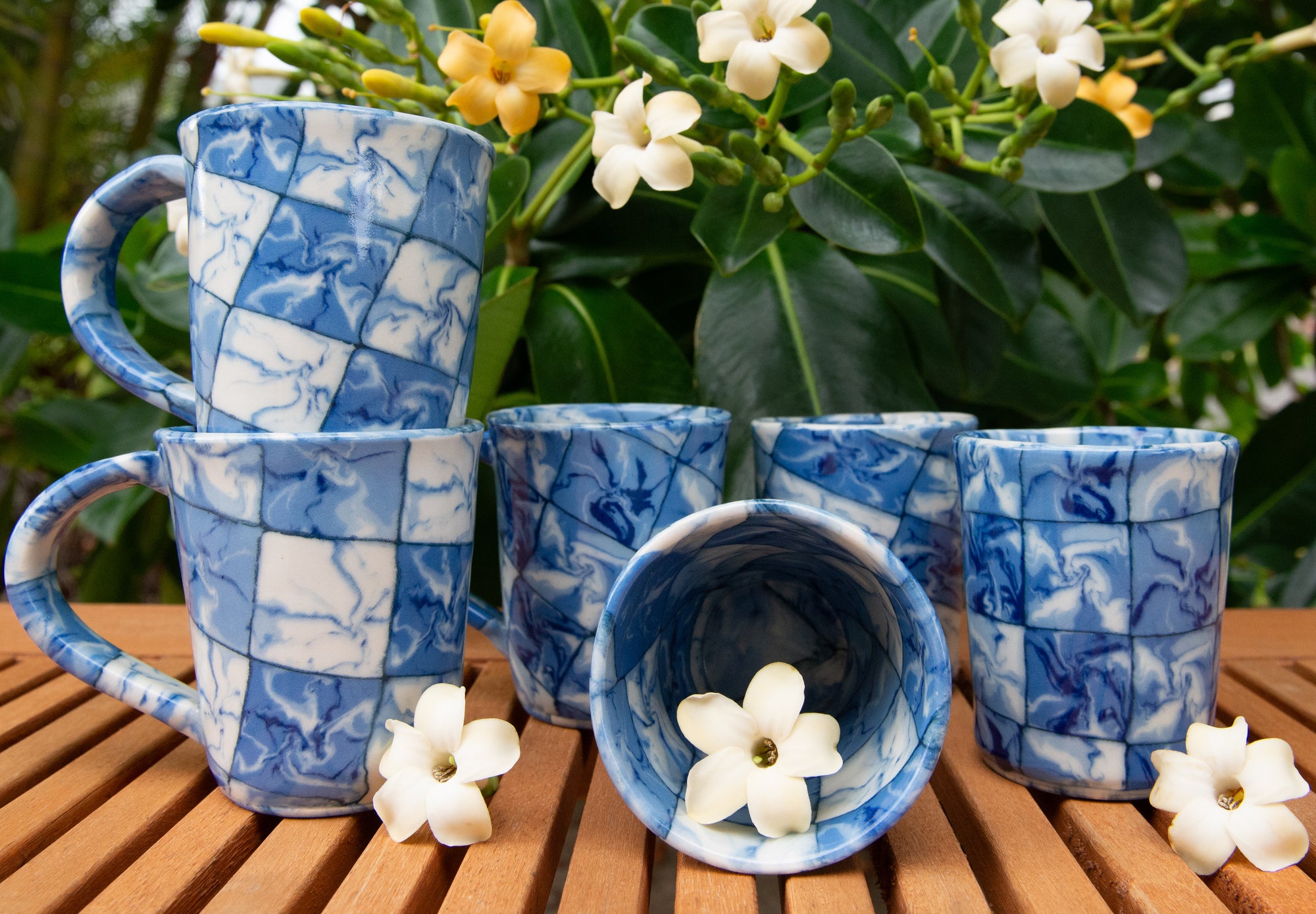 Collection of colorful handmade cups with flowers.